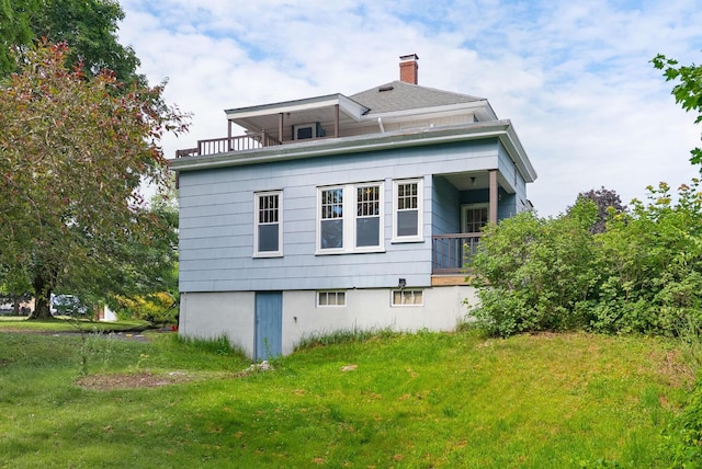 15 Huston Ave, Auburn, ME 04210 - rear view of house with a chimney, a yard, and a balcony