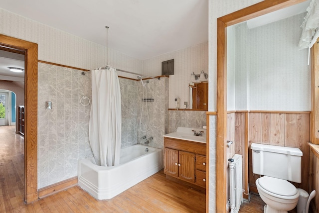 15 Huston Ave, Auburn, ME 04210 - full bath with wallpapered walls, shower / bath combo with shower curtain, wood finished floors, vanity, and radiator