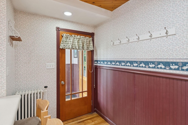 15 Huston Ave, Auburn, ME 04210 - doorway to outside with wallpapered walls, radiator, a wainscoted wall, light wood-style flooring, and recessed lighting