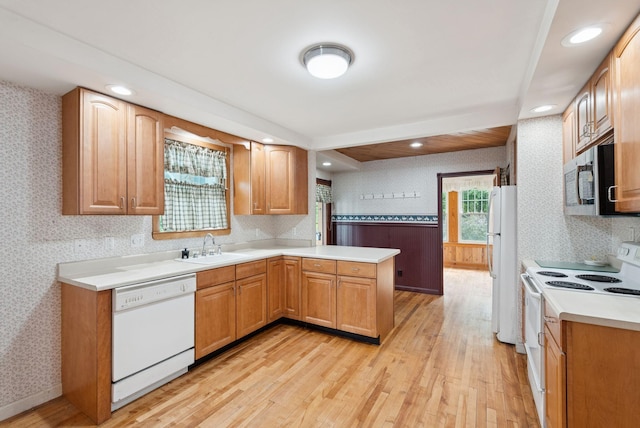 15 Huston Ave, Auburn, ME 04210 - kitchen with white appliances, wallpapered walls, a peninsula, light wood-style floors, and light countertops