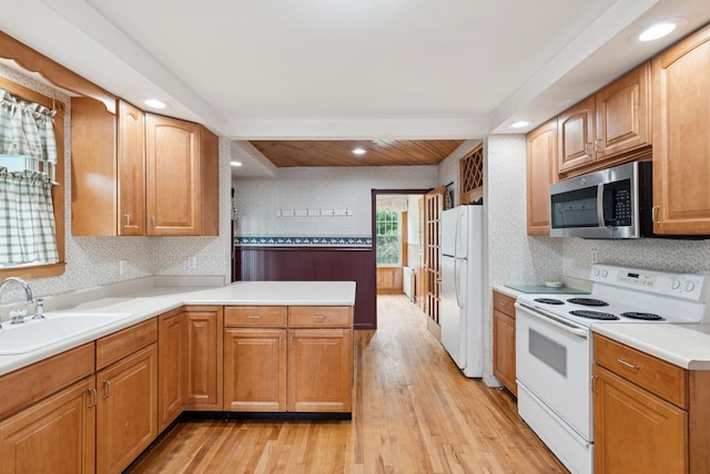 15 Huston Ave, Auburn, ME 04210 - kitchen featuring white appliances, light wood-type flooring, light countertops, a peninsula, and recessed lighting