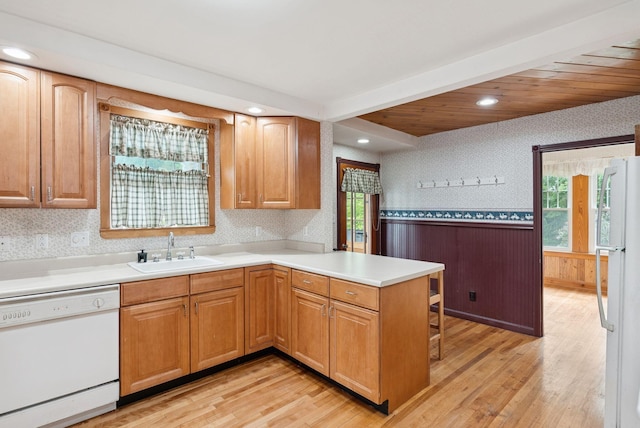 15 Huston Ave, Auburn, ME 04210 - kitchen featuring white appliances, a peninsula, wallpapered walls, a wainscoted wall, and light wood-style flooring