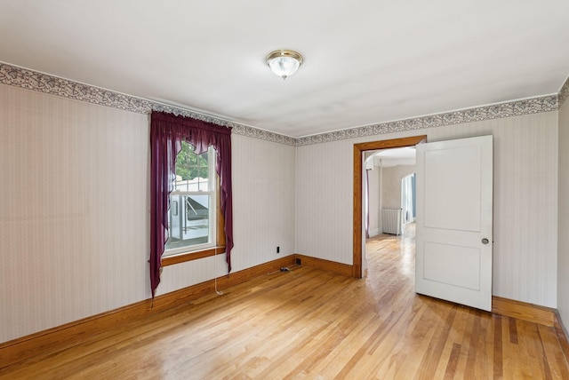 15 Huston Ave, Auburn, ME 04210 - empty room with wallpapered walls and wood finished floors