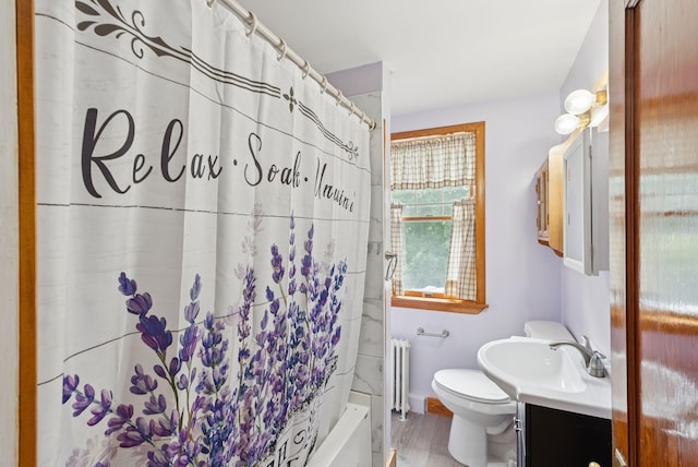 15 Huston Ave, Auburn, ME 04210 - bathroom featuring radiator, vanity, shower / bath combo, and wood finished floors