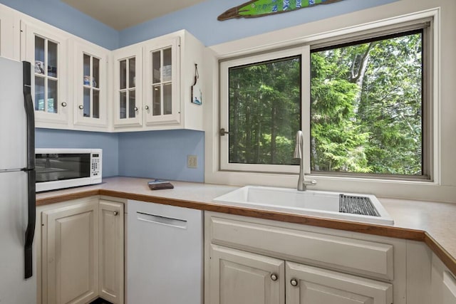 127 Appalachee Rd, Boothbay Harbor, ME 04538 - kitchen featuring white microwave, freestanding refrigerator, light countertops, and white cabinetry