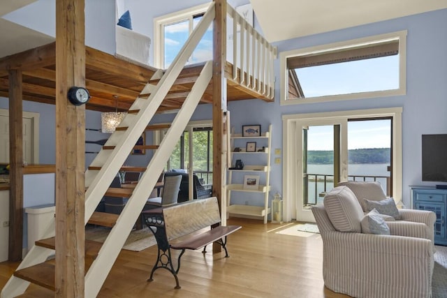 127 Appalachee Rd, Boothbay Harbor, ME 04538 - living room featuring stairs, wood finished floors, and a towering ceiling