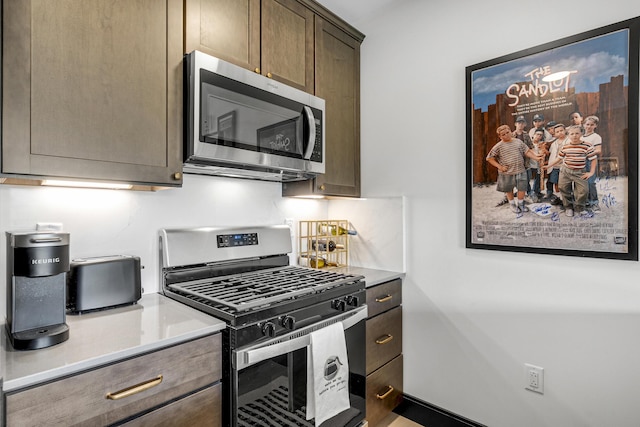 218 Washington Ave Unit 408, Portland, ME 04101 - kitchen with appliances with stainless steel finishes, light countertops, and dark brown cabinetry