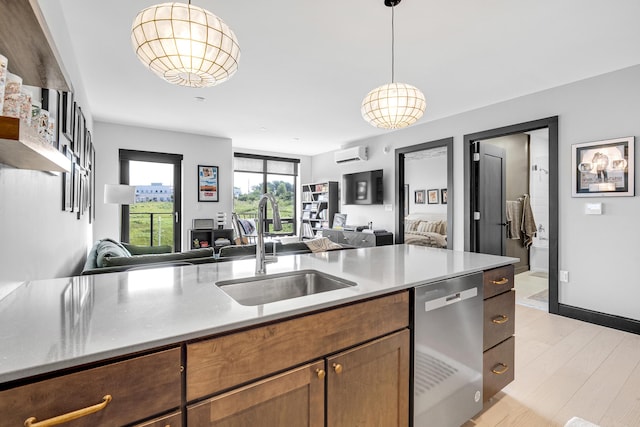 218 Washington Ave Unit 408, Portland, ME 04101 - kitchen with dishwasher, open floor plan, a wall mounted air conditioner, and hanging light fixtures