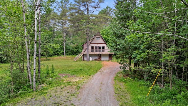 36 Palmer Rd, Etna, ME 04434 - a-frame style home featuring driveway, stairs, a forest view, a deck, and a front yard