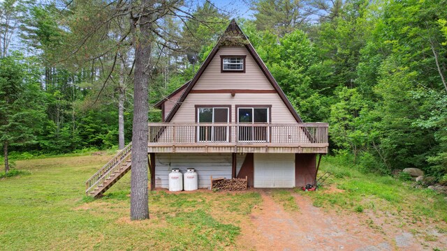 36 Palmer Rd, Etna, ME 04434 - a-frame style home with dirt driveway, a wooden deck, stairway, and a front lawn
