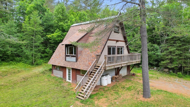 36 Palmer Rd, Etna, ME 04434 - view of front of house with stairway, a deck, dirt driveway, and roof with shingles