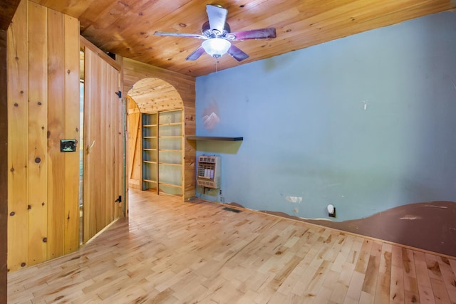 36 Palmer Rd, Etna, ME 04434 - unfurnished living room featuring heating unit, wood finished floors, wood ceiling, a ceiling fan, and wooden walls