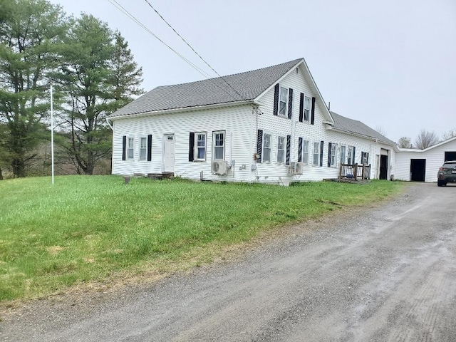 523 Exeter Rd, Corinth, ME 04427 - view of front of property featuring driveway, cooling unit, a garage, and a front lawn