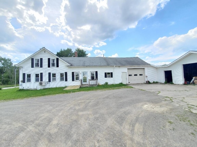 523 Exeter Rd, Corinth, ME 04427 - view of front of home with driveway, a garage, and a chimney