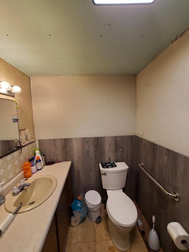 523 Exeter Rd, Corinth, ME 04427 - half bath with vanity, wainscoting, and tile patterned floors