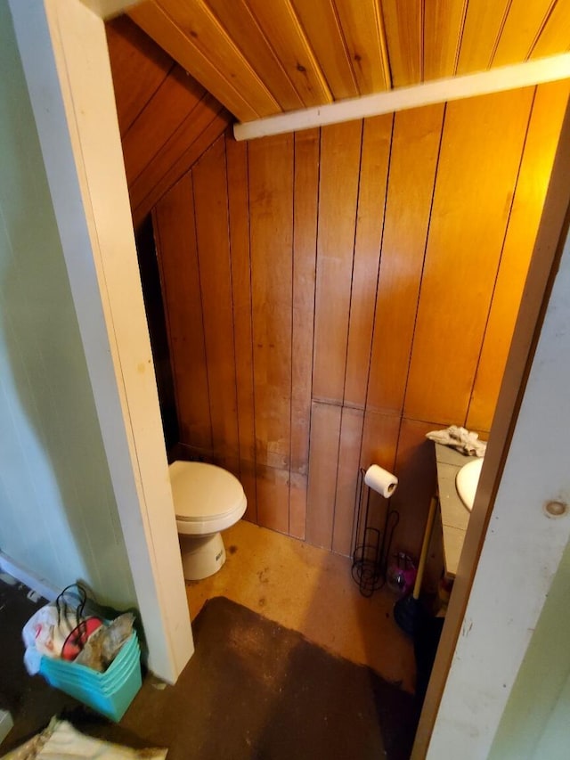 523 Exeter Rd, Corinth, ME 04427 - bathroom featuring toilet and wooden walls