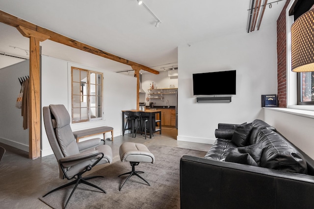 273 Congress St Unit 1, Portland, ME 04101 - living room featuring track lighting, finished concrete floors, and wet bar