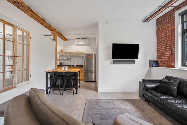 273 Congress St Unit 1, Portland, ME 04101 - living area with wet bar, finished concrete flooring, and a wall mounted air conditioner