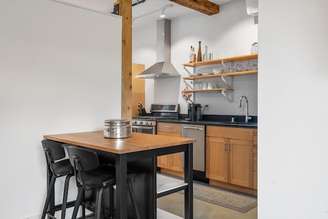 273 Congress St Unit 1, Portland, ME 04101 - kitchen with wall chimney exhaust hood, stainless steel appliances, butcher block counters, open shelves, and an AC wall unit
