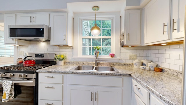 11 Southern Ave, Augusta, ME 04330 - kitchen with appliances with stainless steel finishes, white cabinetry, light countertops, and backsplash