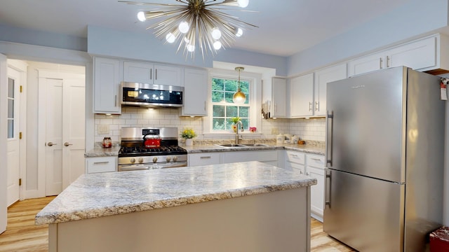 11 Southern Ave, Augusta, ME 04330 - kitchen with stainless steel appliances, light wood-style flooring, white cabinets, and tasteful backsplash