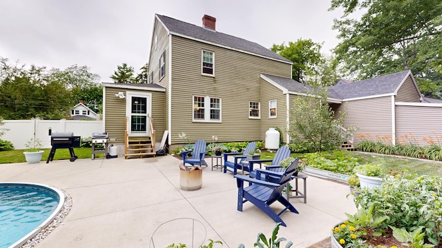 11 Southern Ave, Augusta, ME 04330 - back of house featuring a patio, a shingled roof, and a chimney