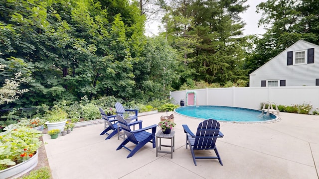 11 Southern Ave, Augusta, ME 04330 - outdoor pool featuring a patio area and view of wooded area