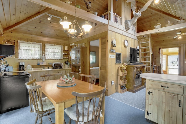 9 Sarah Ln, Standish, ME 04084 - dining room featuring wood walls, a wood ceiling with exposed beams, light colored carpet, a chandelier, and a fireplace