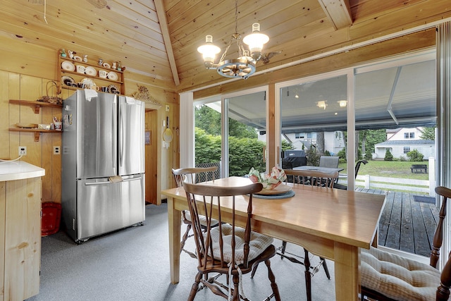 9 Sarah Ln, Standish, ME 04084 - dining area with light carpet, a chandelier, wooden ceiling, wooden walls, and vaulted ceiling