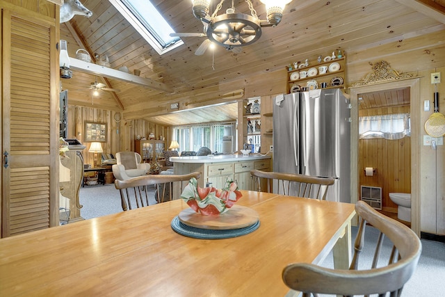 9 Sarah Ln, Standish, ME 04084 - dining room with ceiling fan, wood walls, carpet flooring, lofted ceiling, and a skylight