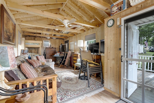 9 Sarah Ln, Standish, ME 04084 - living area featuring plenty of natural light, vaulted ceiling, wooden walls, light wood finished floors, and ceiling fan