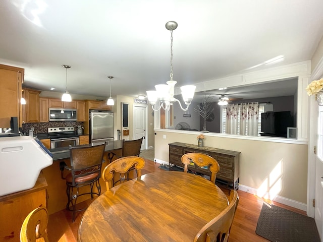 28 Kayla Way, Gorham, ME 04038 - dining space with light wood-style flooring, a chandelier, and a ceiling fan