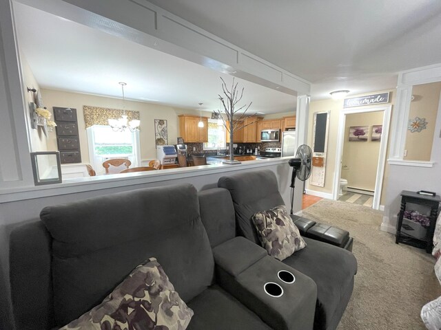 28 Kayla Way, Gorham, ME 04038 - living room featuring a chandelier, healthy amount of natural light, and baseboard heating