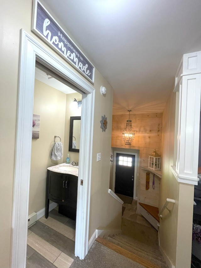 28 Kayla Way, Gorham, ME 04038 - bathroom with a chandelier, vanity, and wood walls
