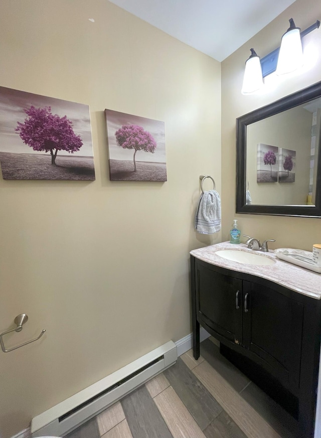 28 Kayla Way, Gorham, ME 04038 - bathroom featuring a baseboard radiator, wood finished floors, and vanity