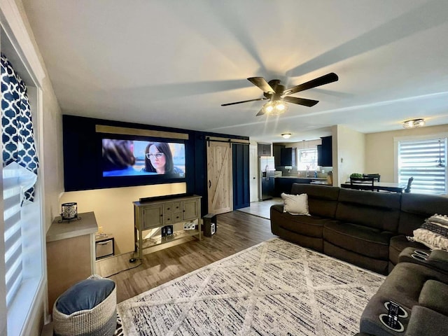 28 Kayla Way, Gorham, ME 04038 - living area with a barn door, wood finished floors, and a ceiling fan
