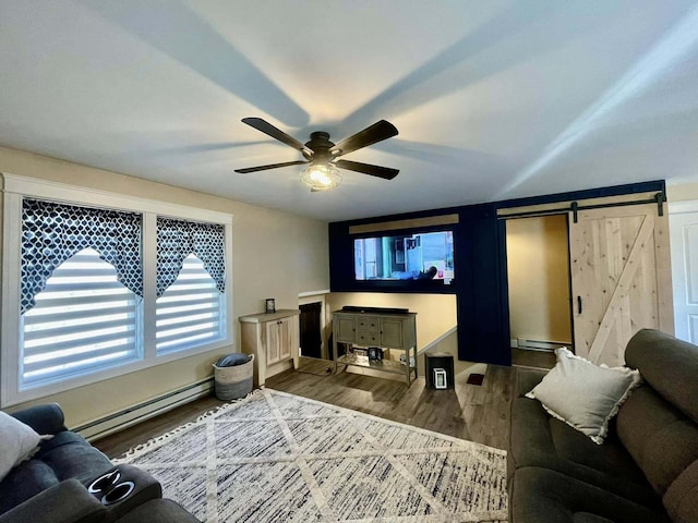 28 Kayla Way, Gorham, ME 04038 - living room featuring a baseboard radiator, a barn door, wood finished floors, and plenty of natural light