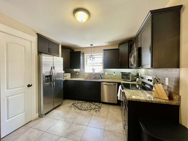 28 Kayla Way, Gorham, ME 04038 - kitchen featuring stainless steel appliances, light stone counters, decorative backsplash, and light tile patterned floors