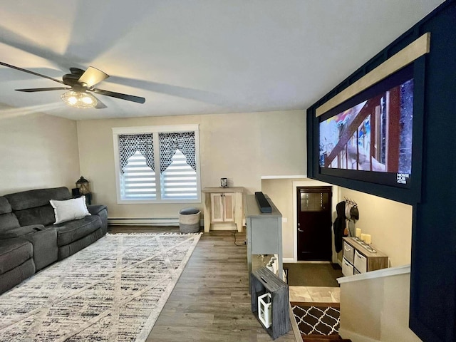 28 Kayla Way, Gorham, ME 04038 - living room with wood finished floors, a ceiling fan, and baseboard heating