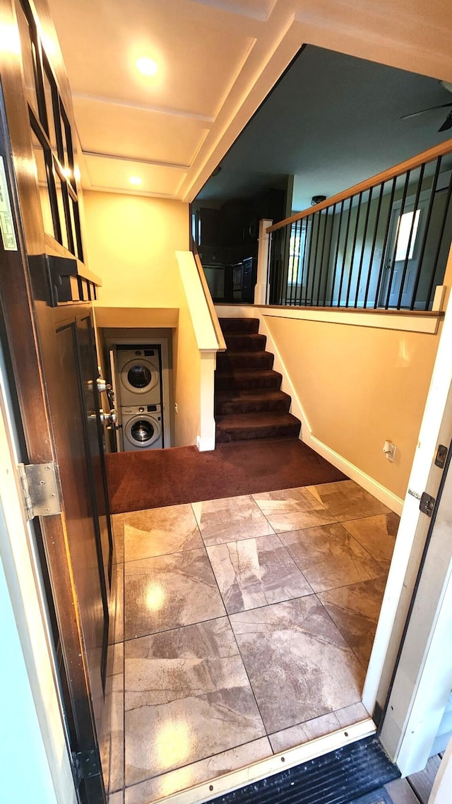 28 Kayla Way, Gorham, ME 04038 - stairs with stacked washer and clothes dryer and baseboards