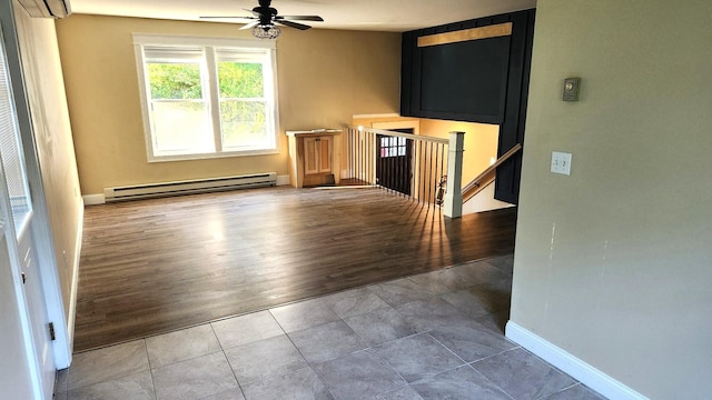 28 Kayla Way, Gorham, ME 04038 - unfurnished living room featuring a baseboard radiator, ceiling fan, a wall mounted air conditioner, and wood finished floors