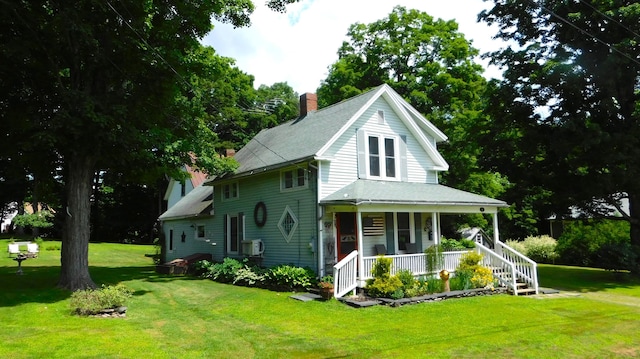10 Liberty St, Dexter, ME 04930 - view of front facade featuring covered porch, a chimney, a front yard, and roof with shingles