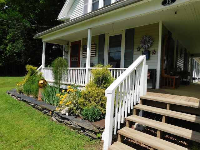 10 Liberty St, Dexter, ME 04930 - doorway to property with a porch and a lawn