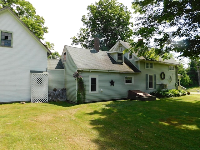 10 Liberty St, Dexter, ME 04930 - rear view of property featuring a lawn, a chimney, and roof with shingles