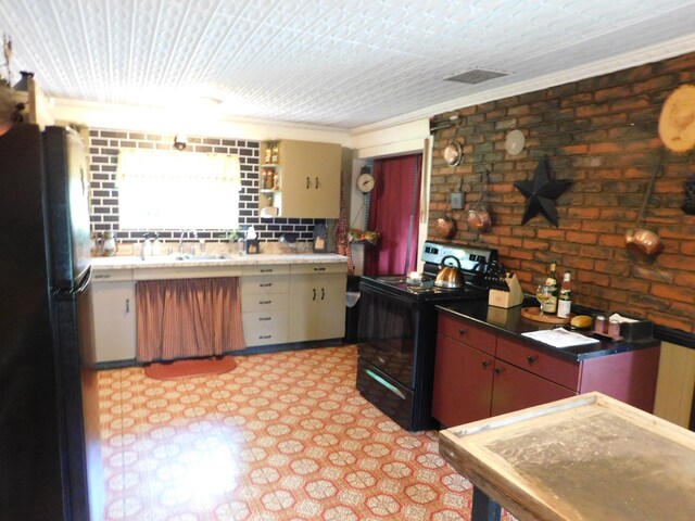 10 Liberty St, Dexter, ME 04930 - kitchen with black appliances, brick wall, light flooring, and ornamental molding