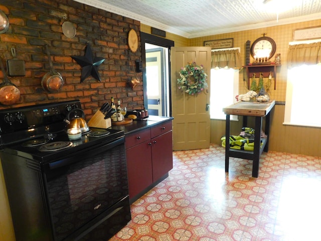 10 Liberty St, Dexter, ME 04930 - kitchen featuring black electric range, light flooring, and ornamental molding