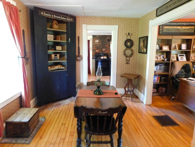 10 Liberty St, Dexter, ME 04930 - dining space featuring wallpapered walls and wood-type flooring