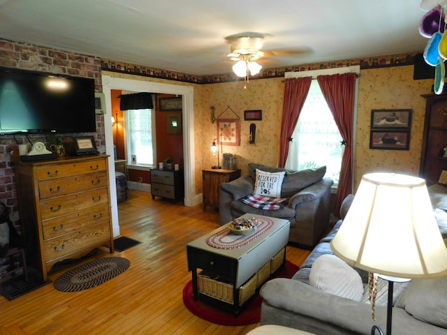 10 Liberty St, Dexter, ME 04930 - living room with plenty of natural light, ceiling fan, wood finished floors, and wallpapered walls