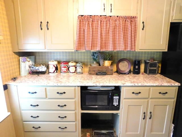 10 Liberty St, Dexter, ME 04930 - kitchen with black appliances, decorative backsplash, and light stone counters