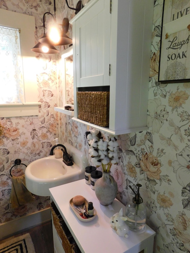 10 Liberty St, Dexter, ME 04930 - half bathroom with wallpapered walls, vanity, and decorative backsplash